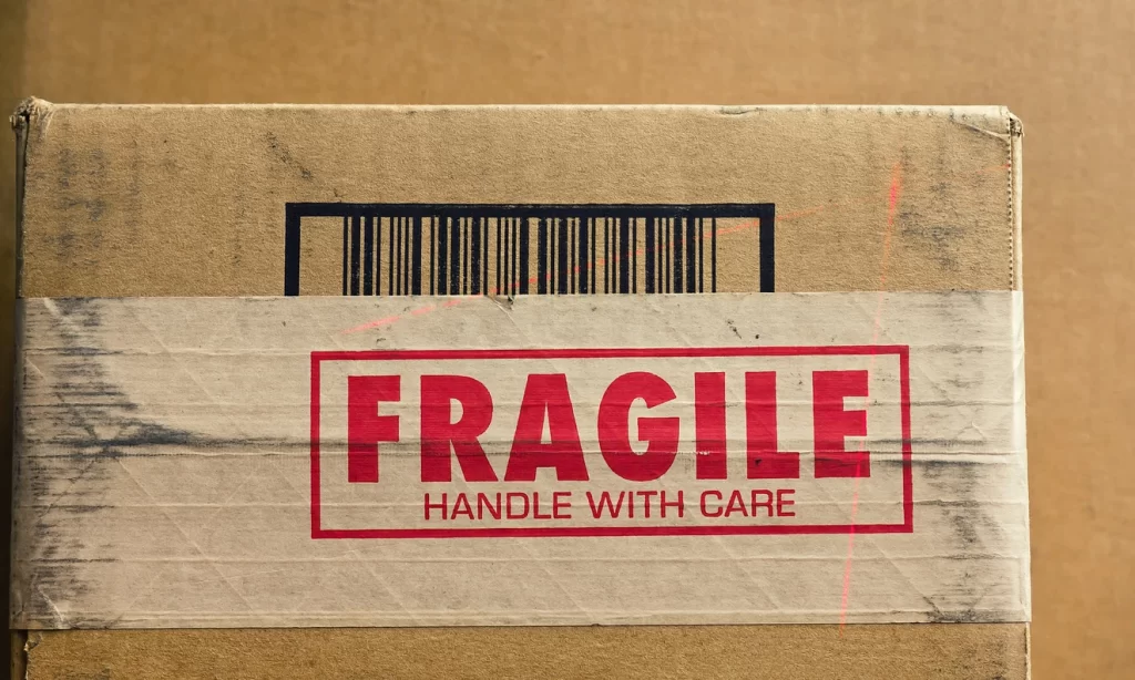 Box labelled FRAGILE HANDLE WITH CARE