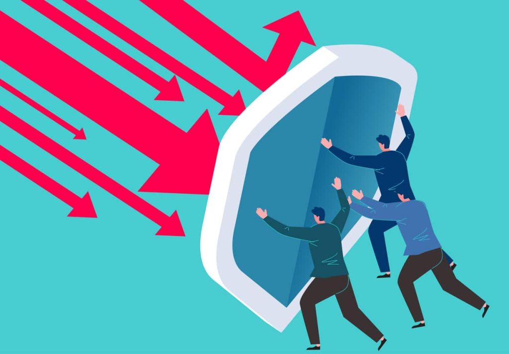 Businessman holding huge shield against falling arrow