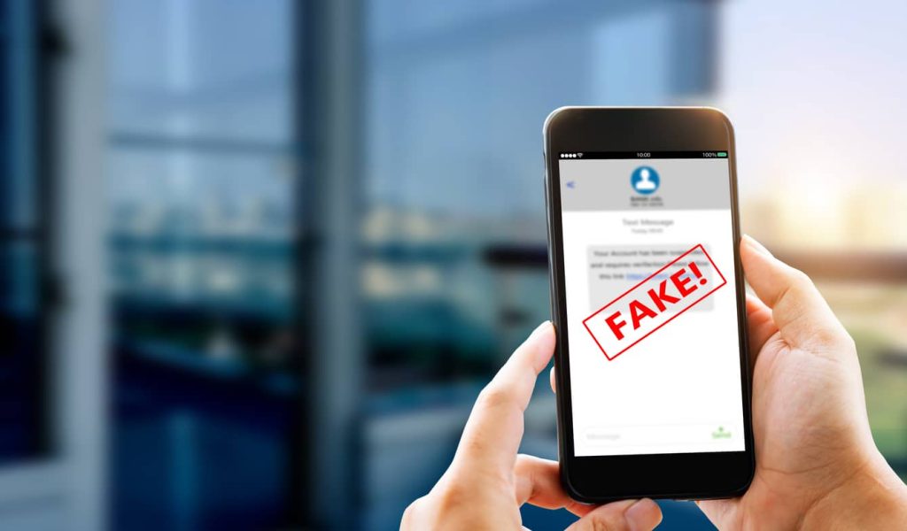 Man using smart phone showing fake Text message SMS scam or phishing concept.